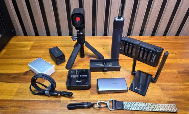 Collection of electronic gadgets including a camera, power banks, charger, and Wi-Fi router.