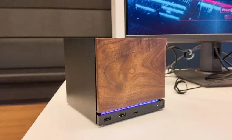 Compact black computer case with a natural wood front panel and blue LED lighting.