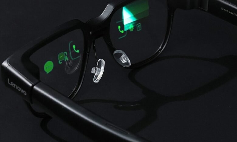 Close-up of black Lenovo smart glasses displaying app icons on the lenses.