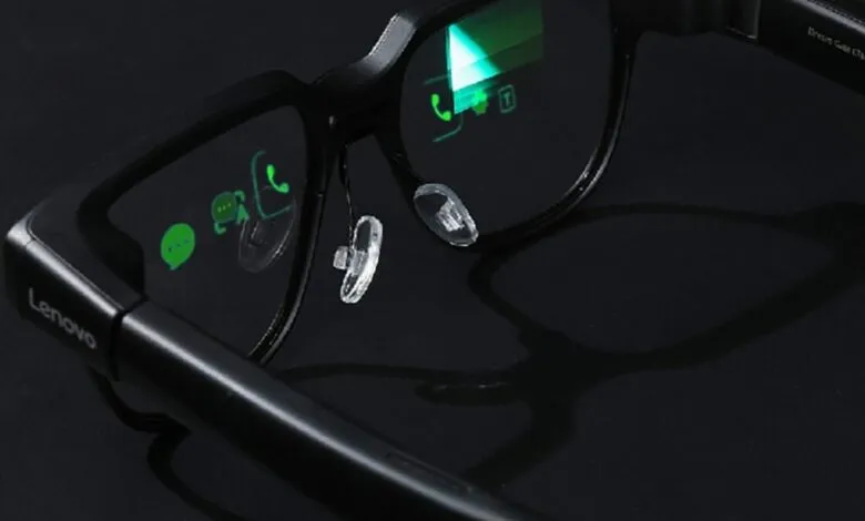 Close-up of black Lenovo smart glasses displaying app icons on the lenses.