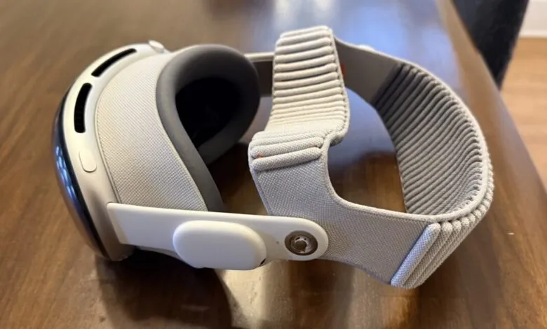 Apple Vision Pro headset resting on a wooden surface, close-up view.