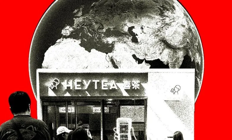 A Heytea store facade with a globe overhead and people waiting in line.