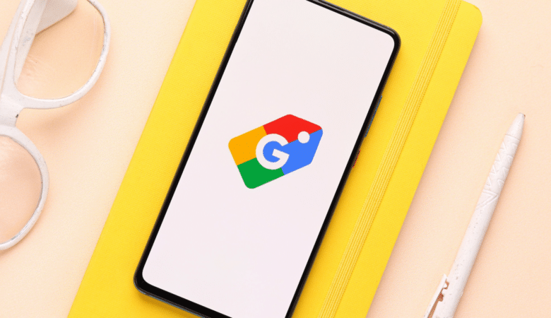 Smartphone displaying the Google Shopping logo on a yellow notepad.