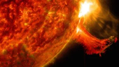 Close-up view of the Sun's surface showing a massive solar flare erupting.