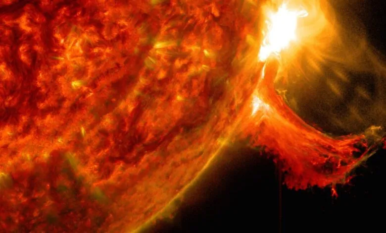 Close-up view of the Sun's surface showing a massive solar flare erupting.