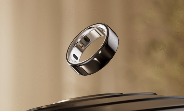 Silver Oura Ring floating above a black charging base.