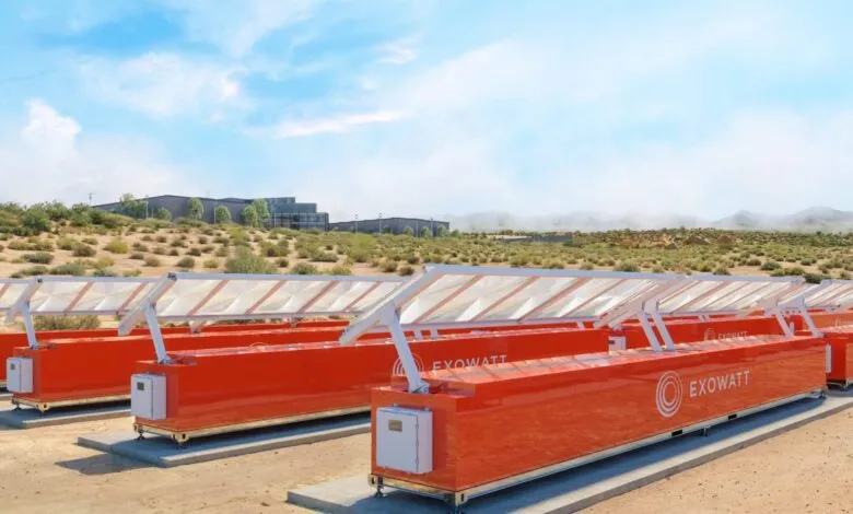 Rows of orange Exowatt energy storage modules with solar panels in a desert landscape.