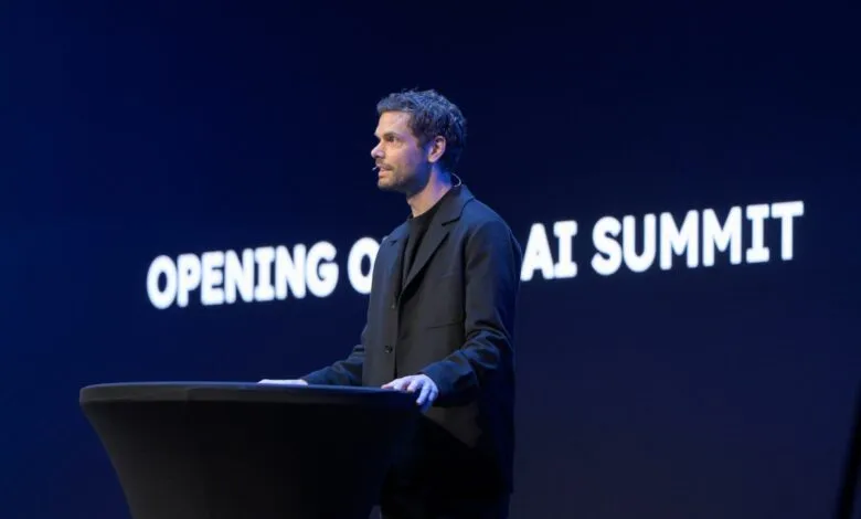 Peter Sarlin speaking at the AI Summit, with a large screen displaying 'OPENING CEREMONY AI SUMMIT'.