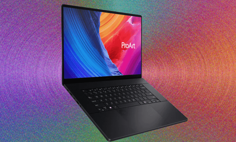 Black Asus ProArt P16 laptop with a vibrant abstract wallpaper on screen.