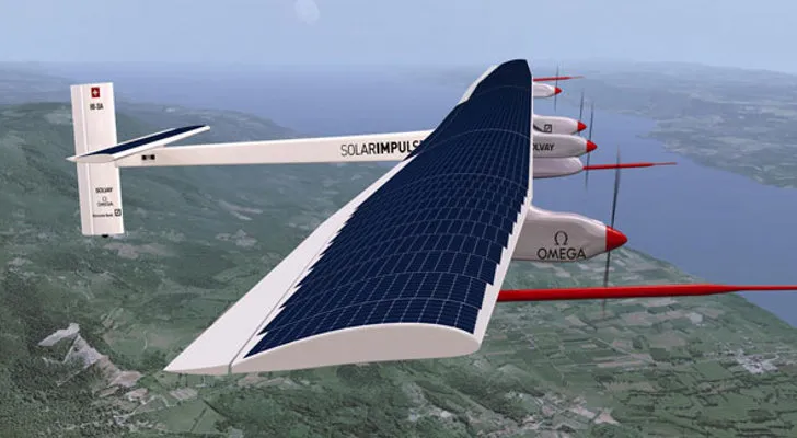 Solar Impulse 2 airplane with solar panels on its wings flying over a landscape.