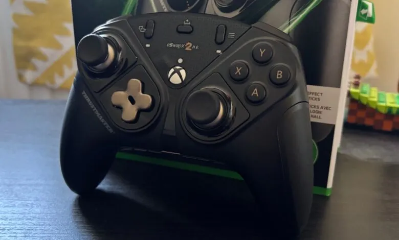 Close-up of a black Thrustmaster eSwap X2 H.E. gaming controller with Xbox buttons.