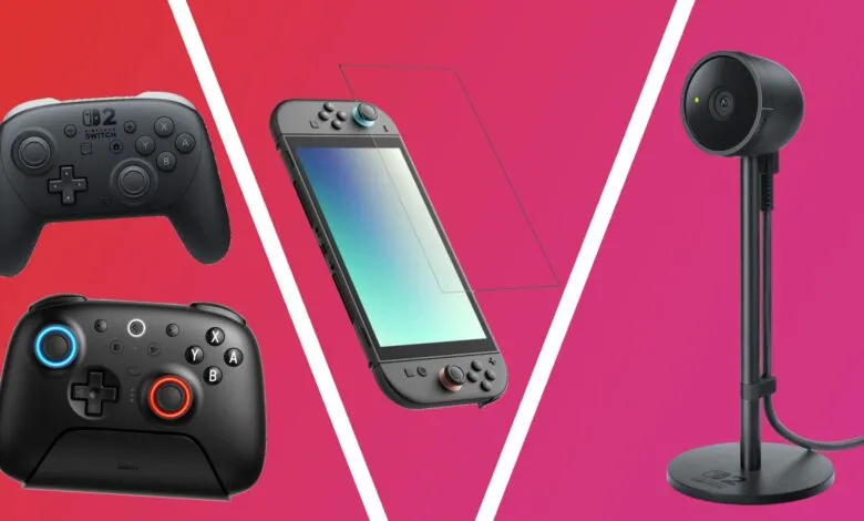 Nintendo Switch controllers, console, and webcam on a pink background.