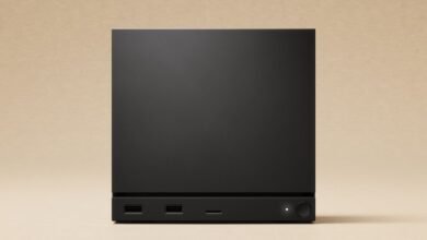 Minimalist black box with USB ports and power button on a beige background.