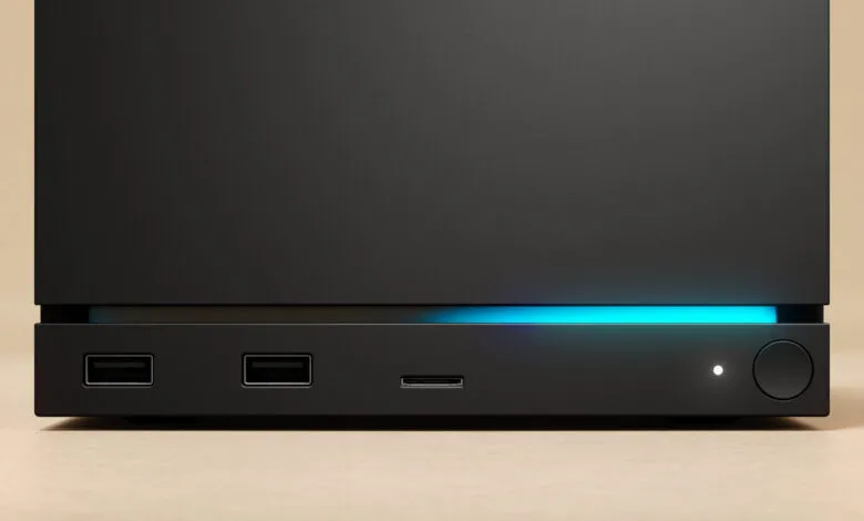 Close-up of a sleek black electronic device with USB ports and a glowing blue light.