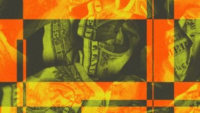 Close-up of crumpled US dollar bills with a glitch art overlay in orange and green.