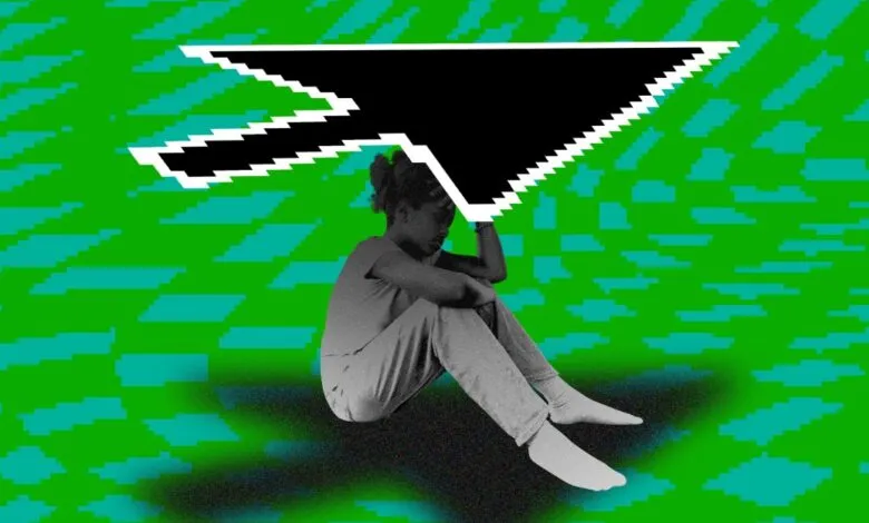 A person sits with their head in their hands under a large pixelated computer cursor.