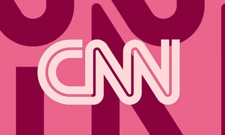 The CNN logo in white with a pink outline, set against a background of varying shades of pink and magenta.