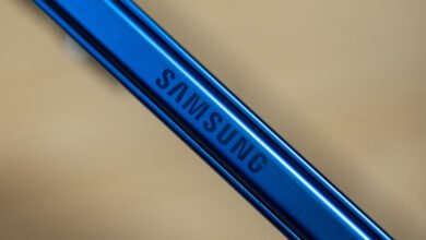 Close-up of the blue Samsung logo etched onto a metallic surface.