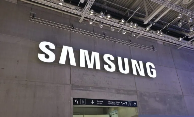 Large, illuminated Samsung logo mounted on a concrete wall at an event.
