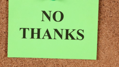 Green sticky note with 'NO THANKS' on corkboard.