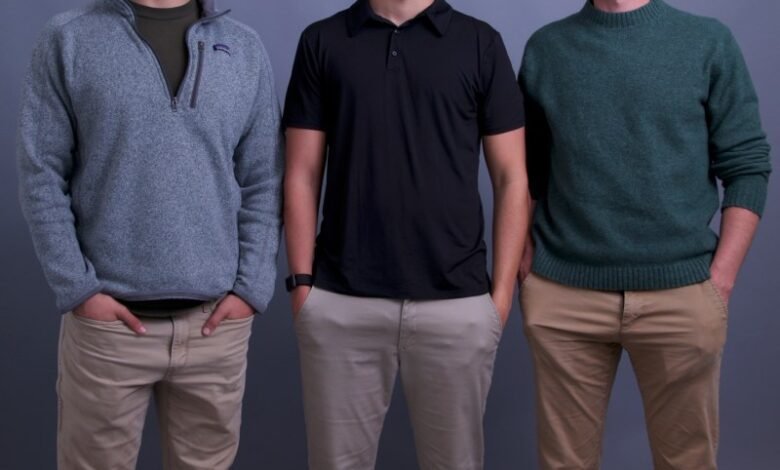 Three young men standing side-by-side, smiling at the camera.