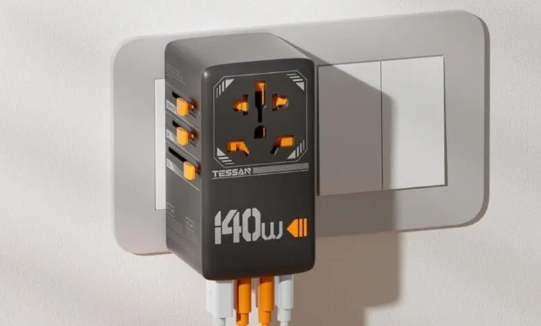 TESSAN universal travel adapter plugged into a wall outlet.