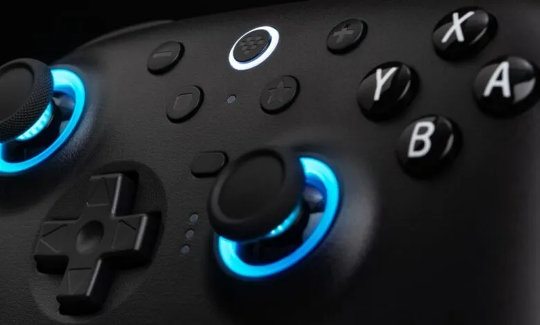 Close-up of a black gaming controller with blue LED accents.