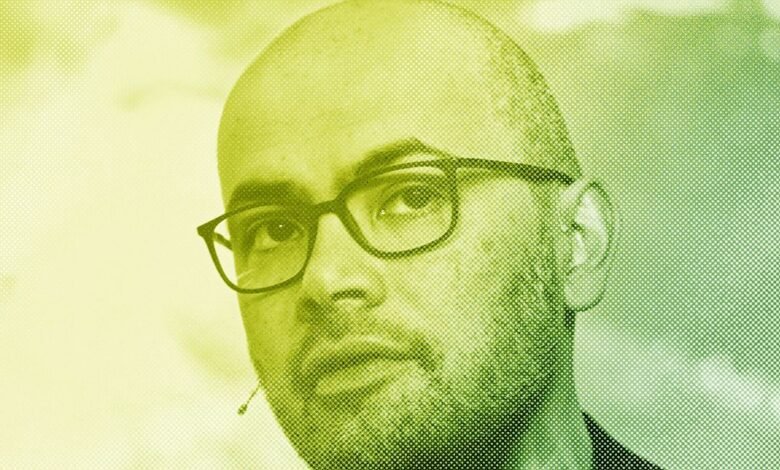 Close-up of a man with glasses in a halftone pattern.