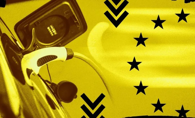 Electric vehicle charging port with plug inserted, overlaid with EU stars and downward arrows.