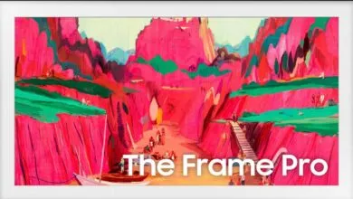 Samsung Frame Pro TV displaying vibrant abstract art of a canyon landscape with figures.