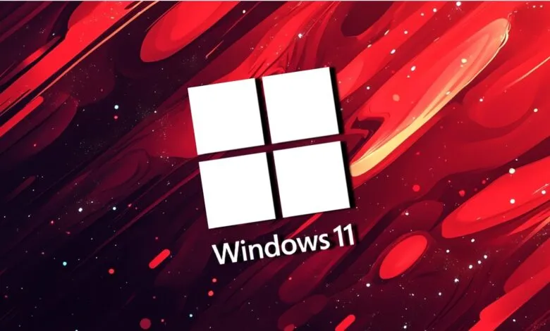 Windows 11 logo on a vibrant red and black abstract background.