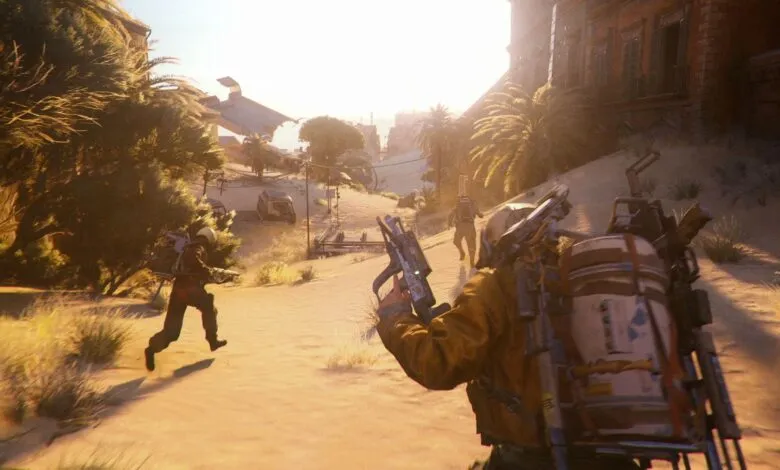 Two figures in futuristic gear running through a desert landscape with a crashed aircraft in the background.