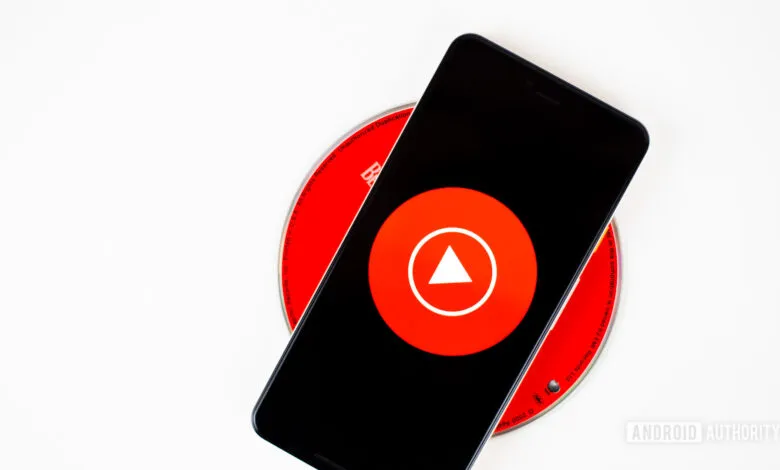 Smartphone displaying the YouTube Music app logo on a red CD.