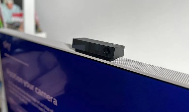 Black webcam mounted on top of a modern television screen.