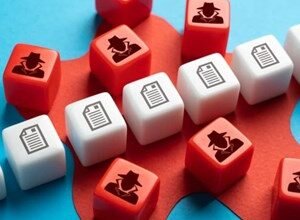 Red and white cubes with icons of a spy and a document scattered on a blue and red background.