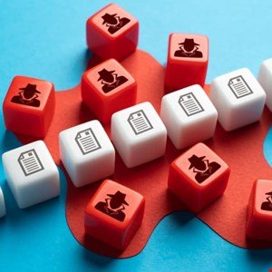 Red and white cubes with icons of a spy and a document scattered on a blue and red background.