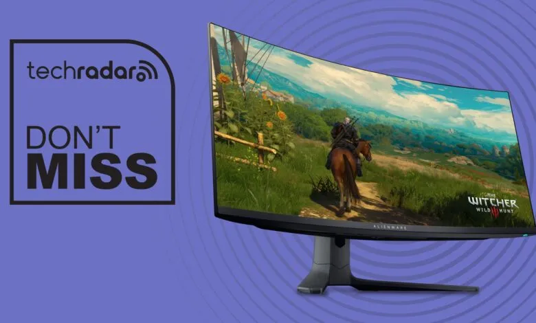 Alienware monitor displays Witcher 3 gameplay, TechRadar logo on left.
