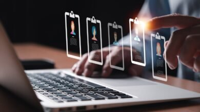 Person selecting a profile from a digital list on a laptop screen.