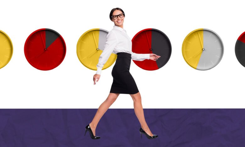 Woman in business attire walking past colorful clocks.