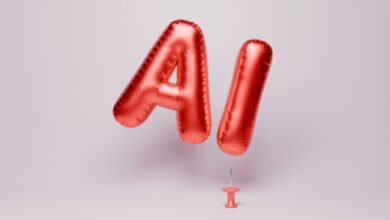 Red foil balloons spelling 'AI' floating above a pink thumbtack.