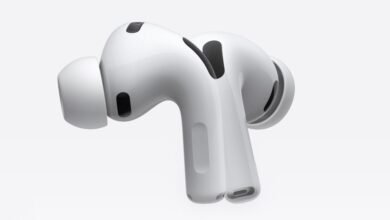 Close-up of white Apple AirPods Pro earbuds on a white background.