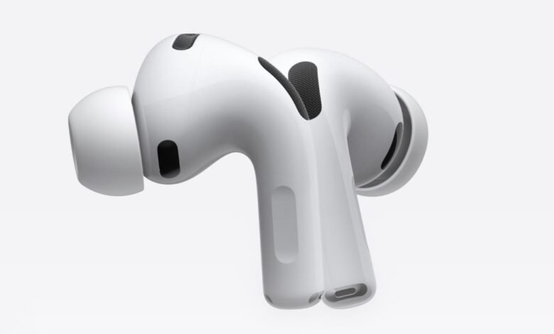 Close-up of white Apple AirPods Pro earbuds on a white background.