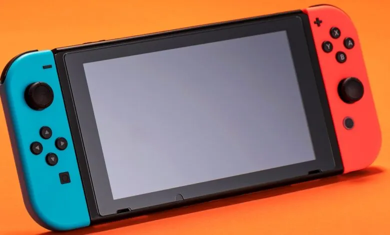 Close-up of a Nintendo Switch gaming console with blue and red Joy-Con controllers.