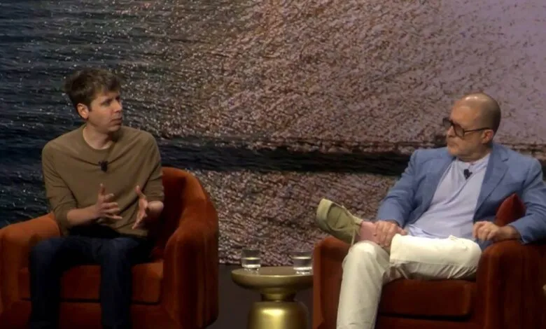 Sam Altman and Jony Ive in conversation, seated in armchairs.