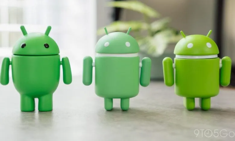 Three green Android robot figures standing in a row.