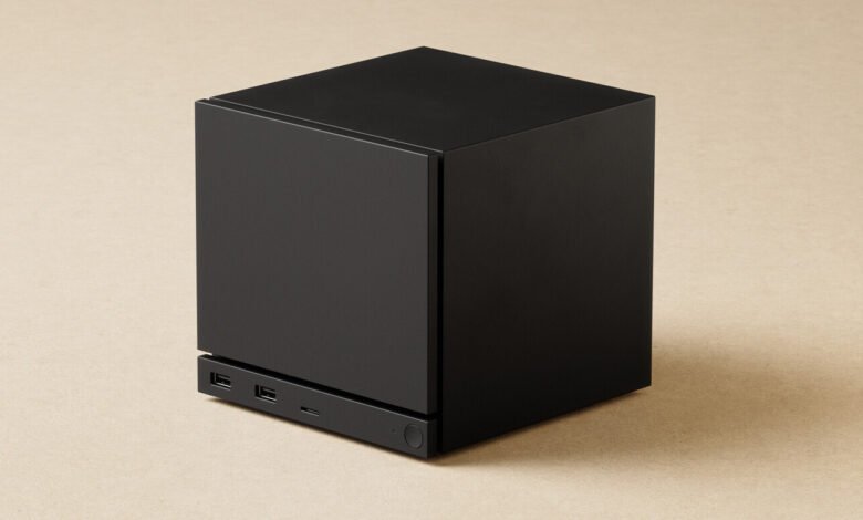 Black cube with USB ports on a tan surface.
