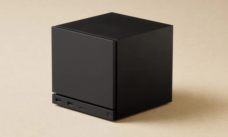 Black cube with USB ports on a tan surface.
