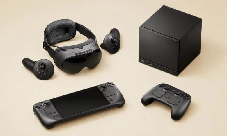 Collection of black gaming devices including a VR headset, controllers, handheld console, and a small black box.