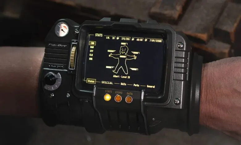 Close-up of a Pip-Boy 3000 device worn on a wrist, displaying character stats.