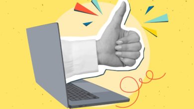 A hand giving a thumbs up emerges from a laptop screen on a yellow background.